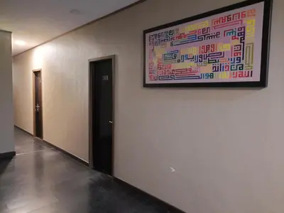 a painting hanging on a wall in a hallway at Hotel Cipta Impian in Kampong Keriting