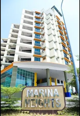 a large building with a sign in front of it at Marina Height Seaview Resort, Teluk Batik, Lumut in Kampong Tebing Rabak