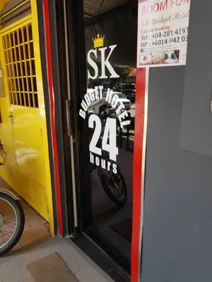 a sign on the door of a motorcycle shop at SK Budget Hotel in Jelutong