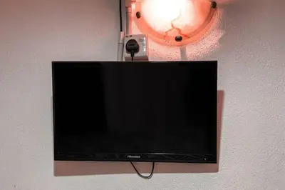 a flat screen tv hanging on a wall at SK Budget Hotel in Jelutong