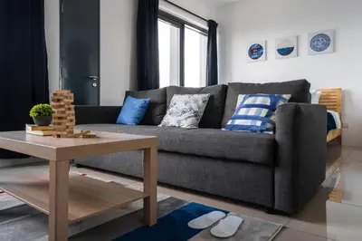 a living room with a couch and a table at MUJI B&W Studio - Seaview at 218 Tropicana NEAR Komtar Food Heaven with Netflix & TV Box in George Town