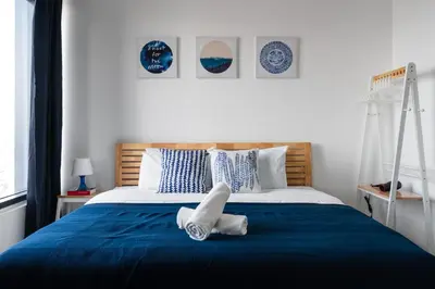 a bedroom with a blue bed with white sheets at MUJI B&W Studio - Seaview at 218 Tropicana NEAR Komtar Food Heaven with Netflix & TV Box in George Town