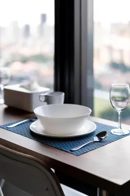 a table with a plate and a glass of wine at MUJI B&W Studio - Seaview at 218 Tropicana NEAR Komtar Food Heaven with Netflix & TV Box in George Town