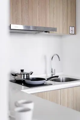a kitchen with two pots and pans on a stove at MUJI B&W Studio - Seaview at 218 Tropicana NEAR Komtar Food Heaven with Netflix & TV Box in George Town