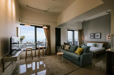 a living room with a couch and a tv at MUJI Studio 2 - Seaview at 218 Tropicana Near Komtar Food Heaven with Netflix & TV Box in George Town