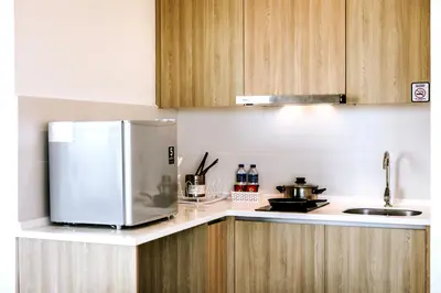 a kitchen with a stainless steel refrigerator and wooden cabinets at MUJI Studio 2 - Seaview at 218 Tropicana Near Komtar Food Heaven with Netflix & TV Box in George Town