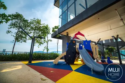 a playground in front of a building with a slide at MUJI Studio 2 - Seaview at 218 Tropicana Near Komtar Food Heaven with Netflix & TV Box in George Town