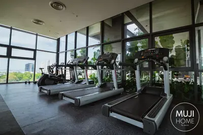 a row of treadmills in a gym with windows at MUJI Studio 2 - Seaview at 218 Tropicana Near Komtar Food Heaven with Netflix & TV Box in George Town