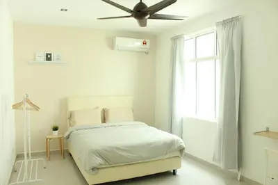 a white bedroom with a bed and a ceiling fan at NEW SEAVIEW Cozy Modern Beach House in Tanjung Bungah