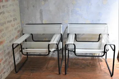 two metal chairs sitting next to a wall at Frenz Republic - SELF CHECK IN in George Town