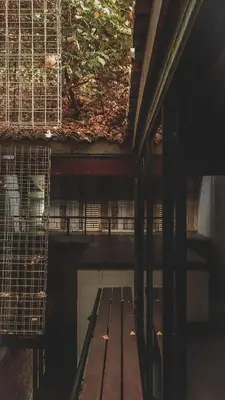 a bird cage with a bench in a building at Frenz Republic - SELF CHECK IN in George Town