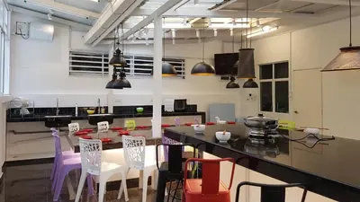 a kitchen with a table and chairs in a room at Rose Hill Gardens in Brinchang