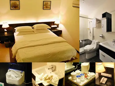 a hotel room with a bed and a sink at ERNES Hotel in Perai
