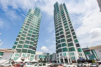 two tall buildings with cars parked in a parking lot at Maritime in George Town