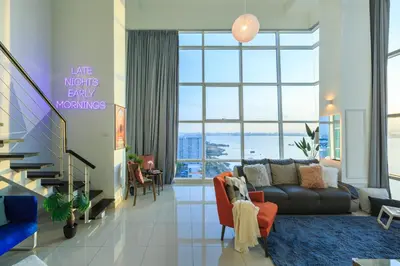 a living room with a couch and a large window at Maritime in George Town