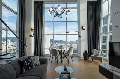 a living room with a table and a large window at Maritime in George Town