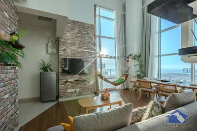 a living room with a couch and a table at Maritime in George Town