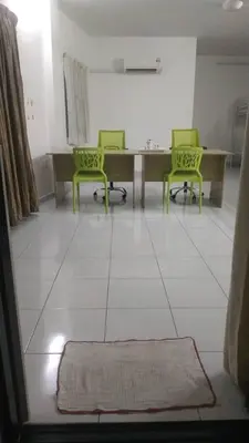 a living room with two green chairs and a table at 15 min to Qing Xin Ling Cultural Village Ipoh in Ipoh
