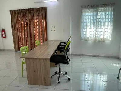an office with a wooden desk and chairs at 15 min to Qing Xin Ling Cultural Village Ipoh in Ipoh