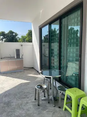 a patio with a table and chairs on a balcony at 15 min to Qing Xin Ling Cultural Village Ipoh in Ipoh