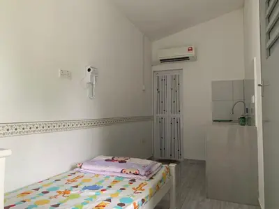 a small white room with a bed in it at 15 min to Qing Xin Ling Cultural Village Ipoh in Ipoh