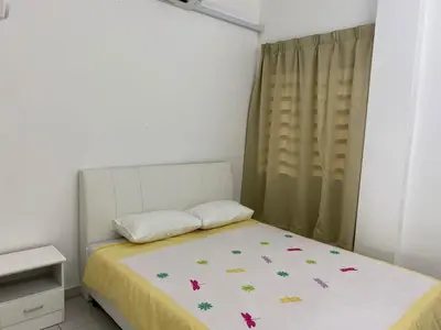 a bedroom with a bed with a yellow blanket and butterflies at 15 min to Qing Xin Ling Cultural Village Ipoh in Ipoh