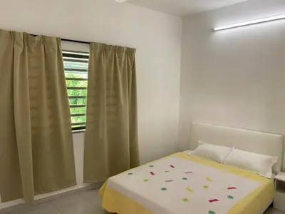 a bedroom with a bed and a window at 15 min to Qing Xin Ling Cultural Village Ipoh in Ipoh