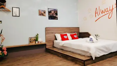 a bedroom with a bed with red pillows on it at Winggarden Murals House by JE Boutique Guesthouse in Ipoh