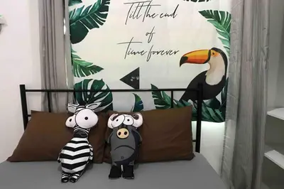 two stuffed animals sitting on top of a bed at be.Animania -8-10mins Lost World Tambun -14-18pax in Ipoh