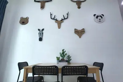a dining room table with chairs and antlers on the wall at be.Animania -8-10mins Lost World Tambun -14-18pax in Ipoh