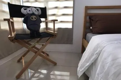 a chair with a painting of a monkey on it in a bedroom at be.Animania -8-10mins Lost World Tambun -14-18pax in Ipoh