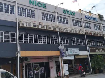 a building on the corner of a street at NICE STAY HOTEL in Raub