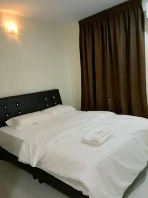 a white bed with a black head board and a window at 28 Gred Hotel in Bukit Mertajam