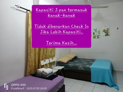 a sign for a bedroom with a bed and a chair at FAFA ROOMSTAY TANJUNG MALIM in Tanjung Malim