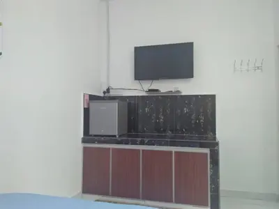 a living room with a tv on a wall at FAFA ROOMSTAY TANJUNG MALIM in Tanjung Malim