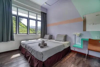 a bedroom with a bed with a teddy bear on it at Parkland Express in Brinchang