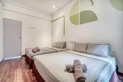 two beds sitting next to each other in a room at Parkland Express in Brinchang