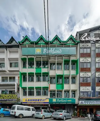 a building with cars parked in front of it at Parkland Express in Brinchang