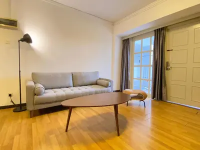 a living room with a couch and a table at Parkland Suites in Brinchang