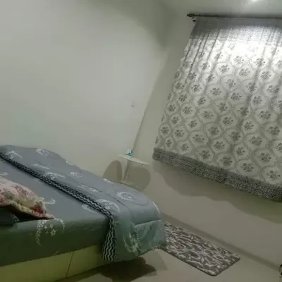 a bed and a window in a room at TRIPLE A Homestay in Ipoh