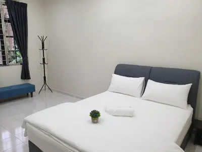 a white bed with a plant on top of it at Taiping Cuti Homstay \u592a\u5e73\u7af9\u7b1b\u6c11\u5bbf 5mins to Kuala Sepetang in Taiping