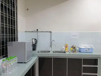 a kitchen counter with a sink and a refrigerator at Taiping Cuti Homstay \u592a\u5e73\u7af9\u7b1b\u6c11\u5bbf 5mins to Kuala Sepetang in Taiping