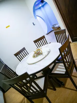 a table with four chairs and a plate of food on it at Gather Here 62 5BR Town Center 5 Rooms in Taiping