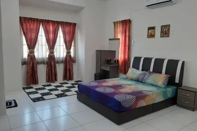 a bedroom with a bed in a room with windows at HM Homestay Lahat, Station 18, Ipoh 'مسلم' in Lahat
