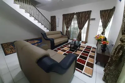 a living room with a couch and a chair at HM Homestay Lahat, Station 18, Ipoh 'مسلم' in Lahat