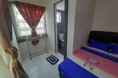a small bedroom with a bed and a shower at HM Homestay Lahat, Station 18, Ipoh 'مسلم' in Lahat