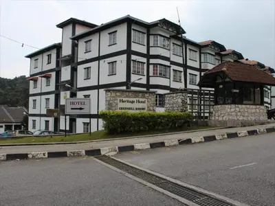 a large white building on the side of a street at Green Hill Resort Tanah Rata 3R2B WiFi in Tanah Rata