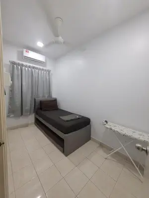 a waiting room with a black couch in a room at Ipoh Meru Modern Cozy Home NAZ IPOH HOMESTAY in Ipoh