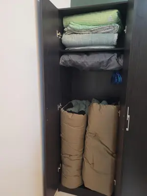 a closet with some folded shirts and pillows at Ipoh Meru Modern Cozy Home NAZ IPOH HOMESTAY in Ipoh