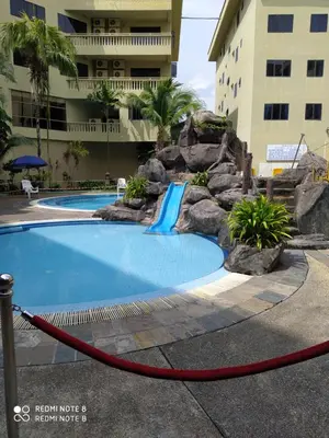 a pool with a water slide in a resort at Pangkor fun fun fun apartment in Pangkor
